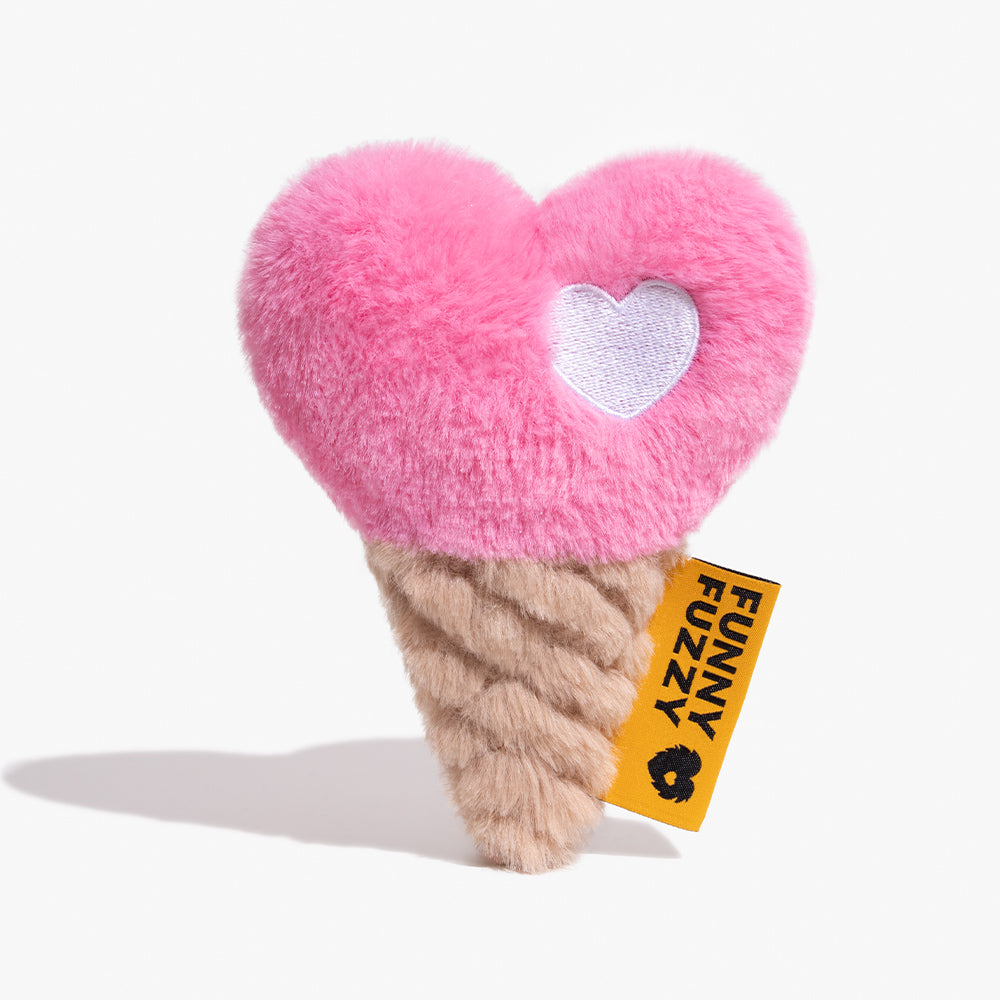 A happy small dog excitedly playing with the FunnyFuzzy ChillHeart Ice Cream Plush Squeaker Dog Toy, showing its vibrant colors and heart shape.