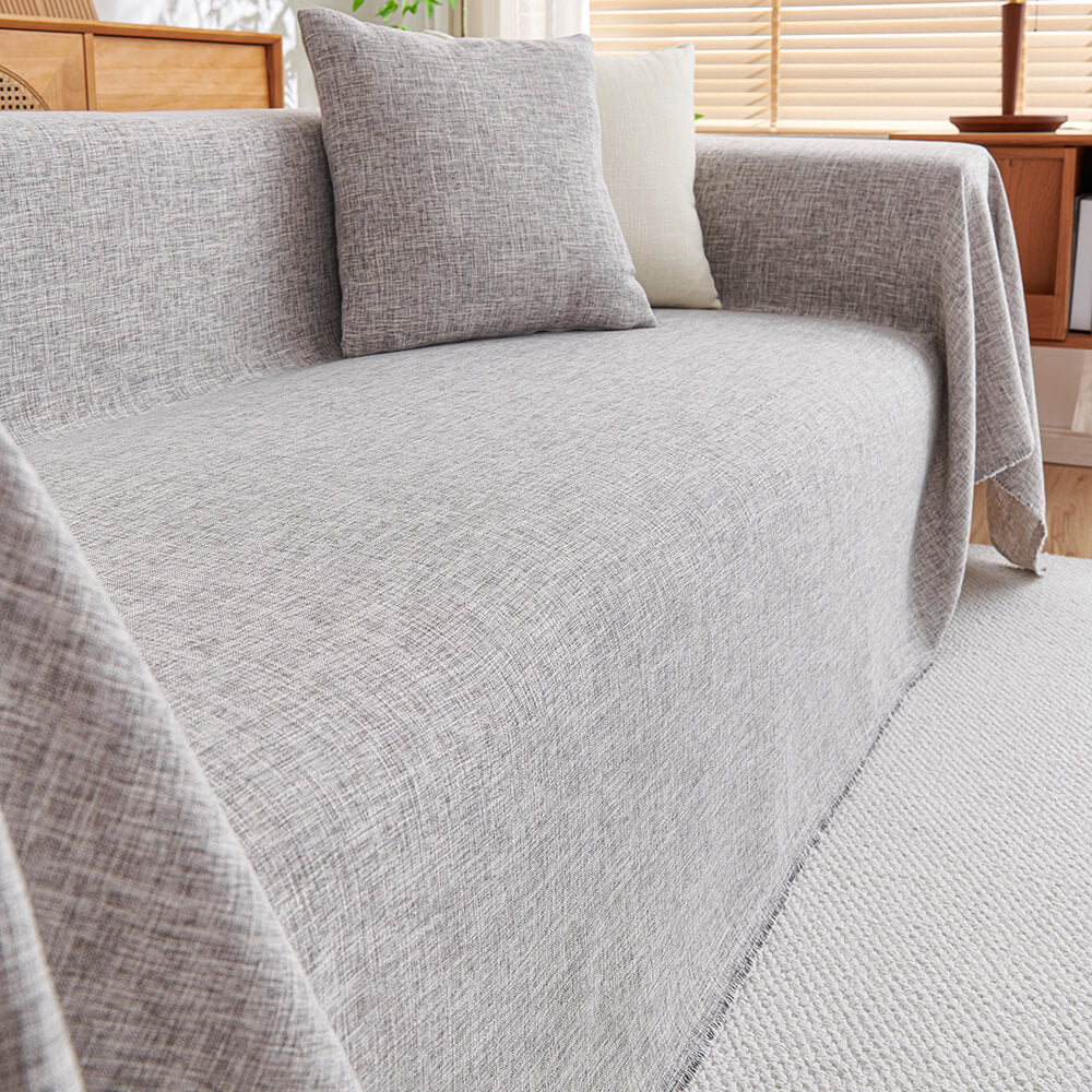 Close-up of the elegant linen fringe couch protector showcasing its texture and color.