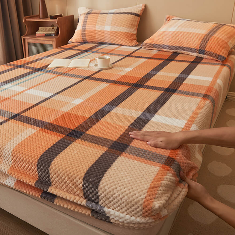 Angled overhead shot of the velvet sheet laid on a queen-size mattress, showcasing its pineapple grid texture