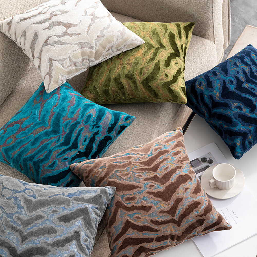 Luxurious jacquard velvet cushion beautifully styled on a modern sofa.