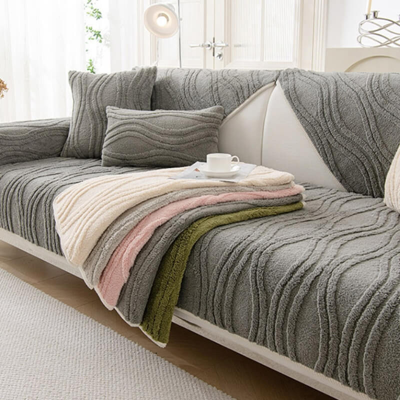 Elegant grey textured plush couch cover on a modern sofa, showcasing its stylish design and non-slip features.
