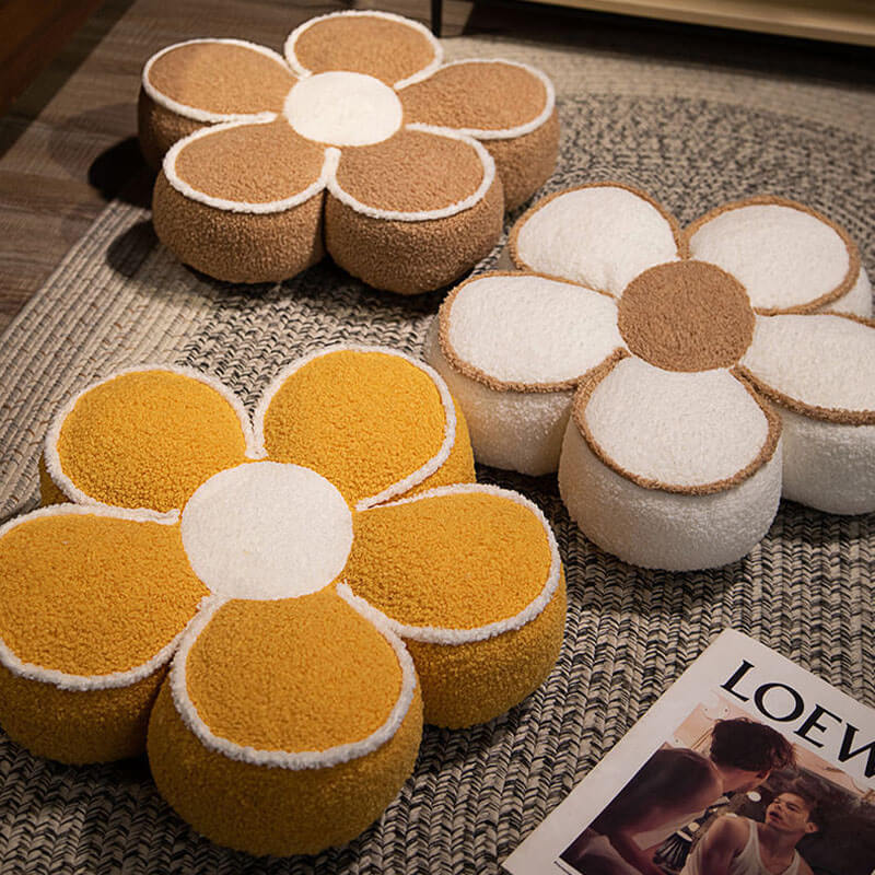 Overhead view of the plush flower cushion styled on a modern sofa, highlighting its decorative texture