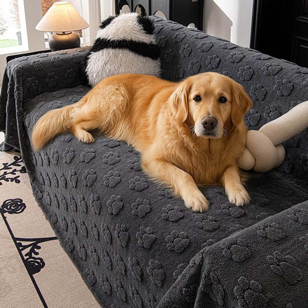 Plush paw-patterned sofa cover draped over a sectional couch