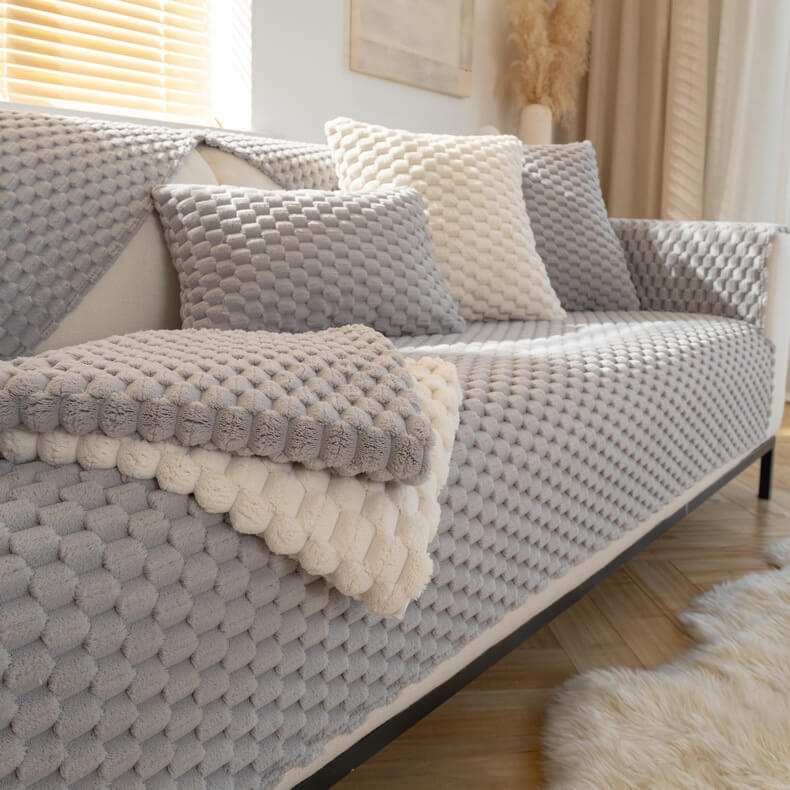 CozyGuard Thickened Plush Sofa Cover on a sofa, protecting it from pet hair and scratches