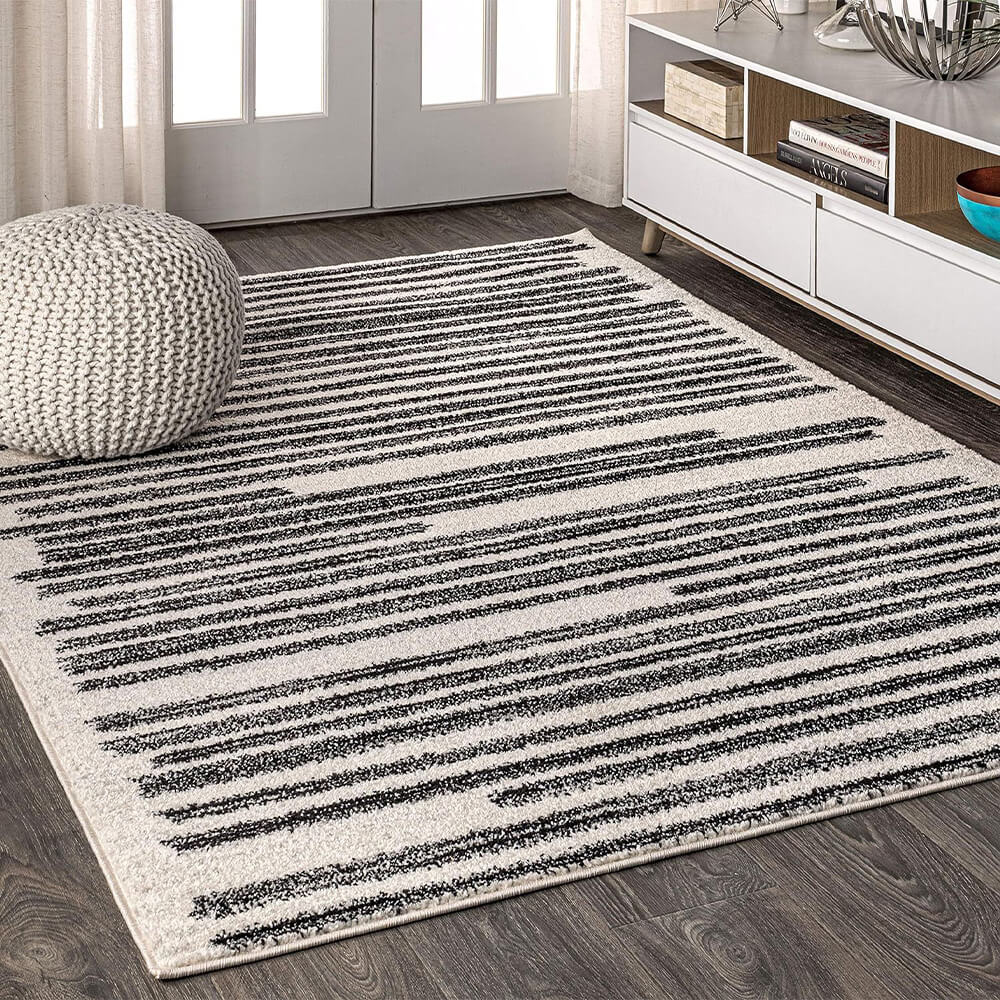 Overhead view of the faux cashmere rug placed in a contemporary living room with soft natural light