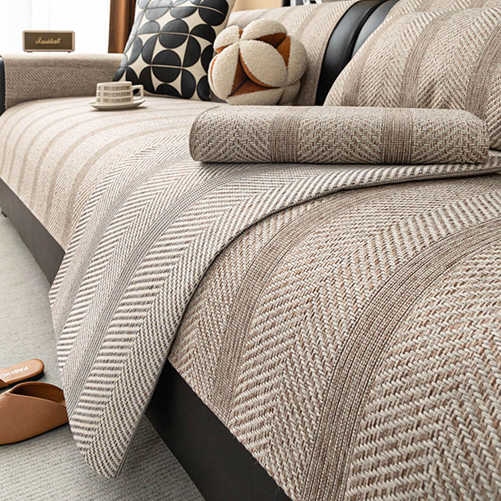 Front-facing view of the faux linen couch cover with textured herringbone pattern in beige