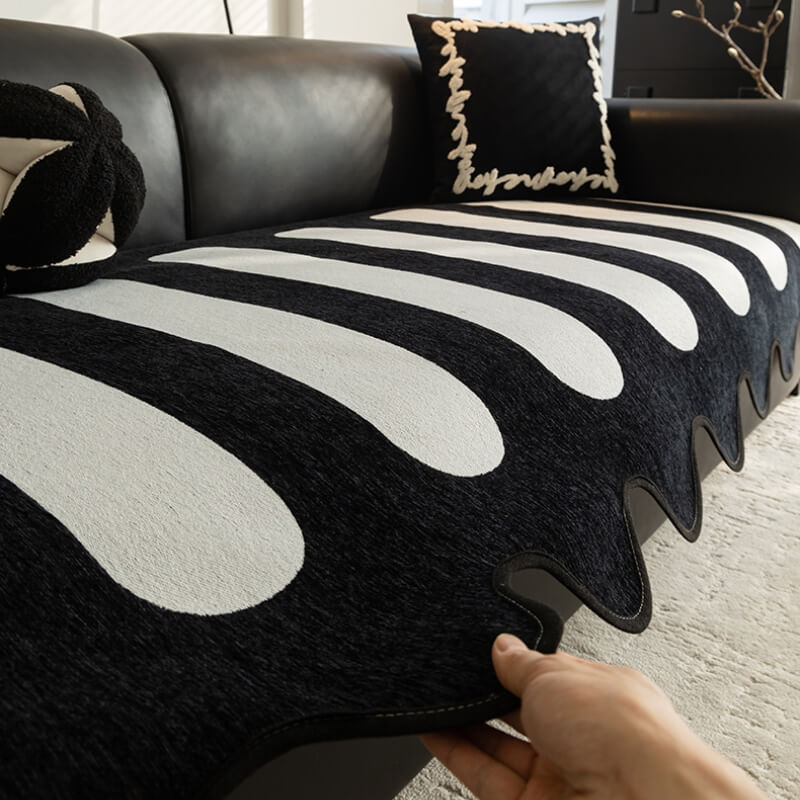 Close-up of black chenille fabric on sofa cover showing plush texture