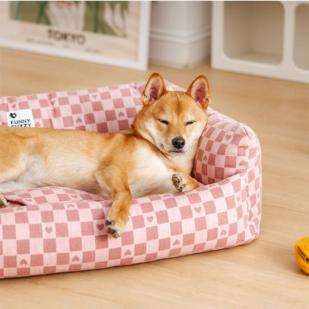 Reversible plaid dog sofa bed with removable cover in a cozy living room