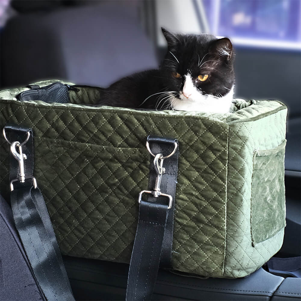A small dog comfortably nestled in a velvet quilted center console dog car seat, showing the plush interior and secure fit.