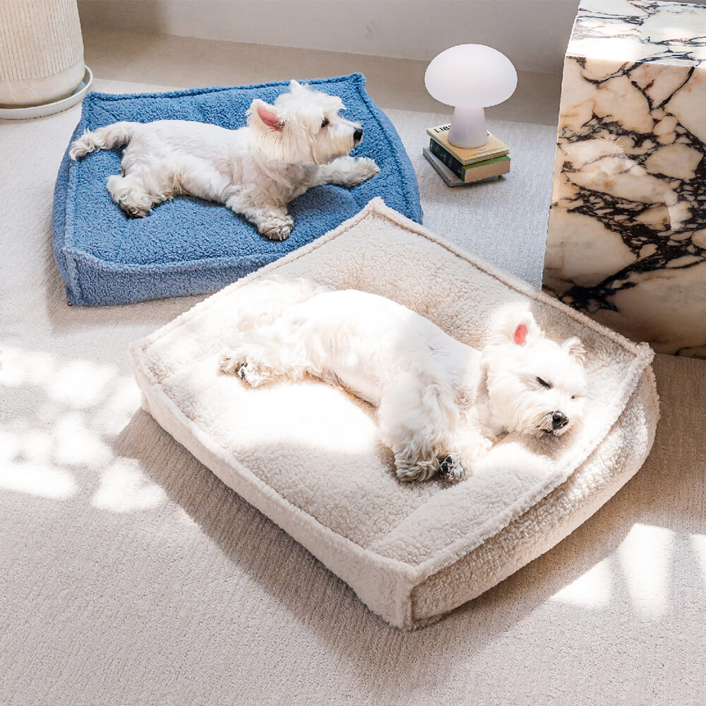 Close-up of the orthopedic pet bed showing the plush teddy fleece texture and curved bolster support