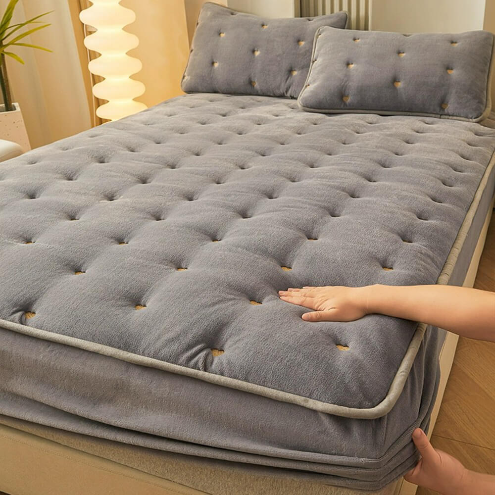Luxurious milk velvet warm quilted mattress cover on a bed, showcasing its softness and warmth.