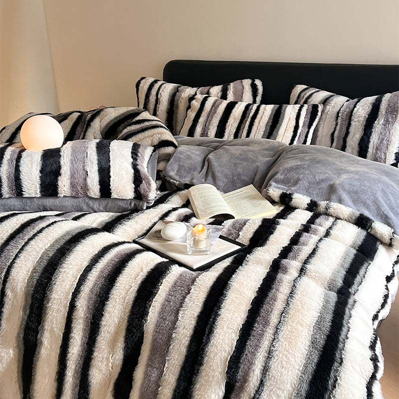 Queen size luxury bed sheet set in gradient ombre stripes displayed on a modern platform bed