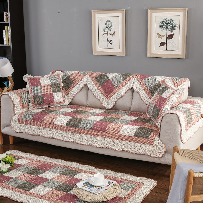 Cotton quilted non-slip sofa cover in elegant living room.