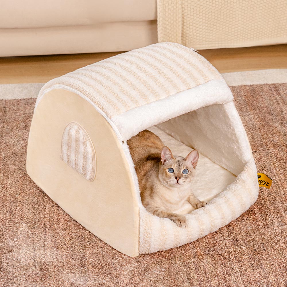 Close-up of luxury cat bed's striped fabric and plush entrance, showcasing cozy cat house design.