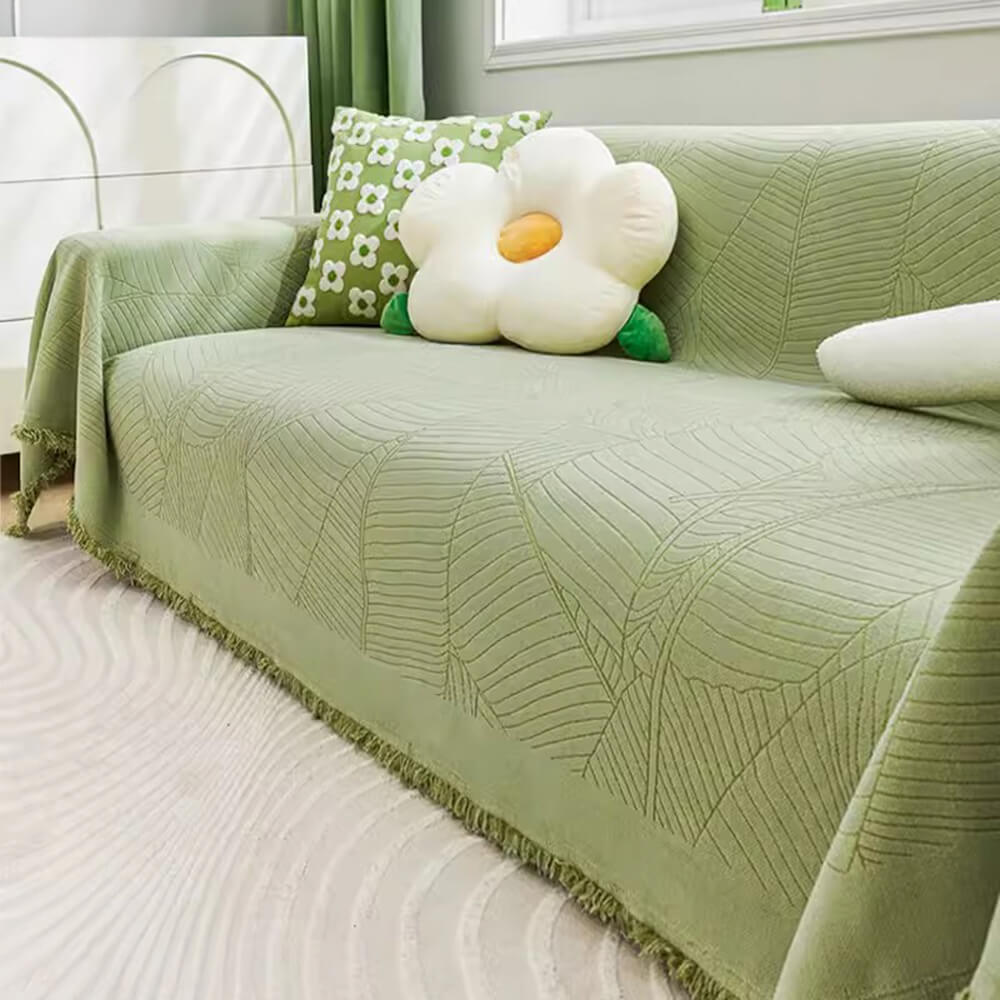 Elegant leaf chenille sofa cover draped over a couch, showcasing its beautiful design and texture.