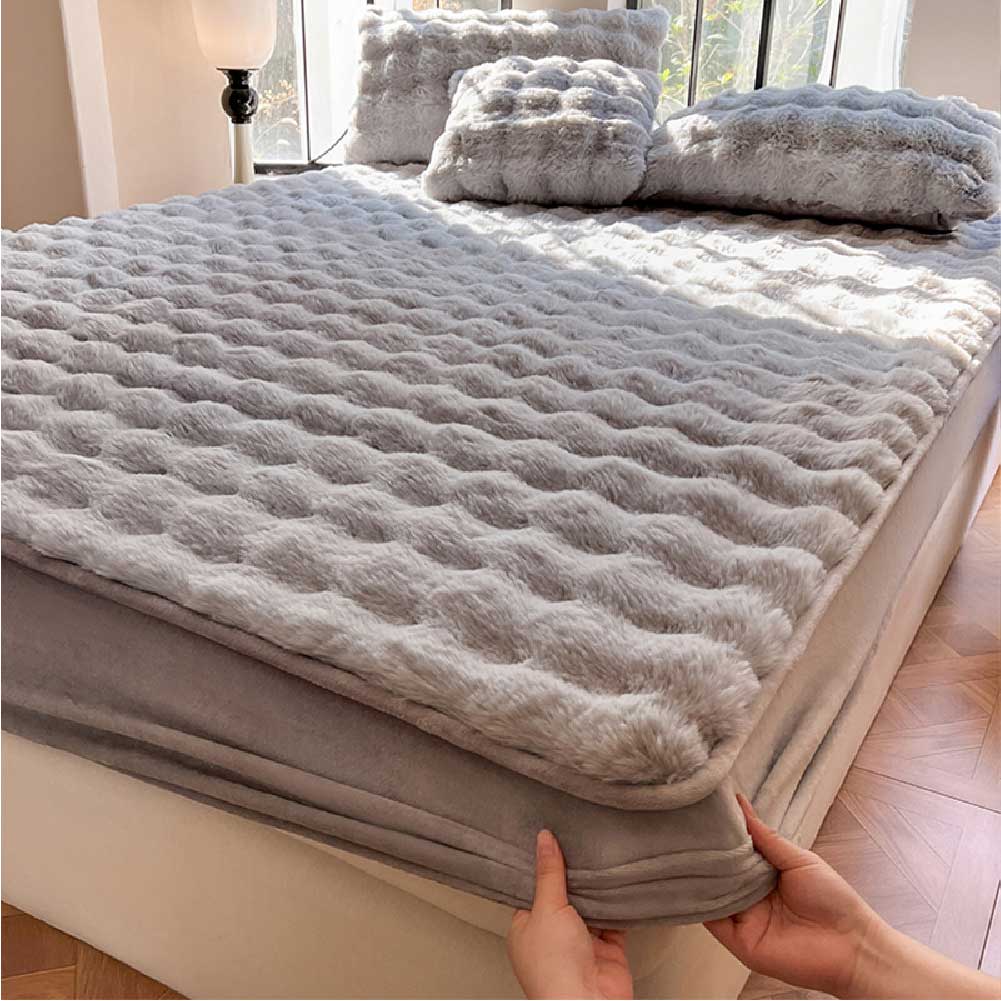 Cozy bubble velvet mattress protector on a bed with pets