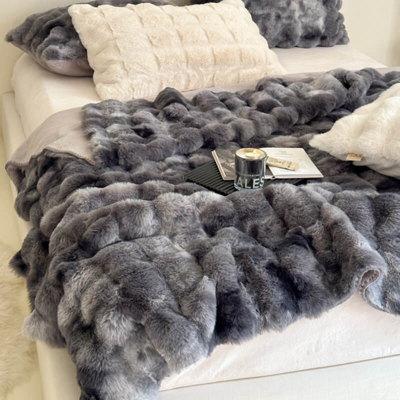 Luxury faux fur throw blanket draped over a couch, perfect for cozying up with pets.