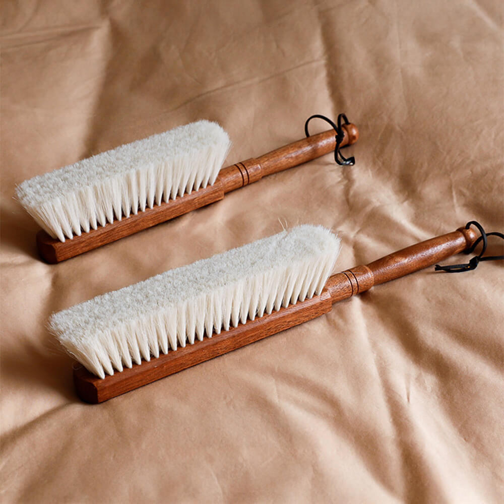 Elegant sandalwood dusting brush showcasing soft wool bristles and ergonomic design.