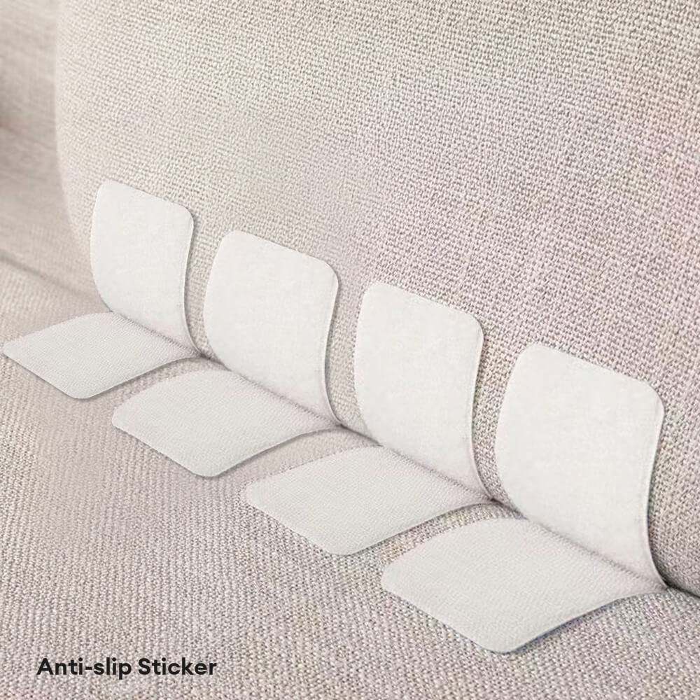 Close-up of StickNest adhesive tabs securing a linen couch cover with invisible grip