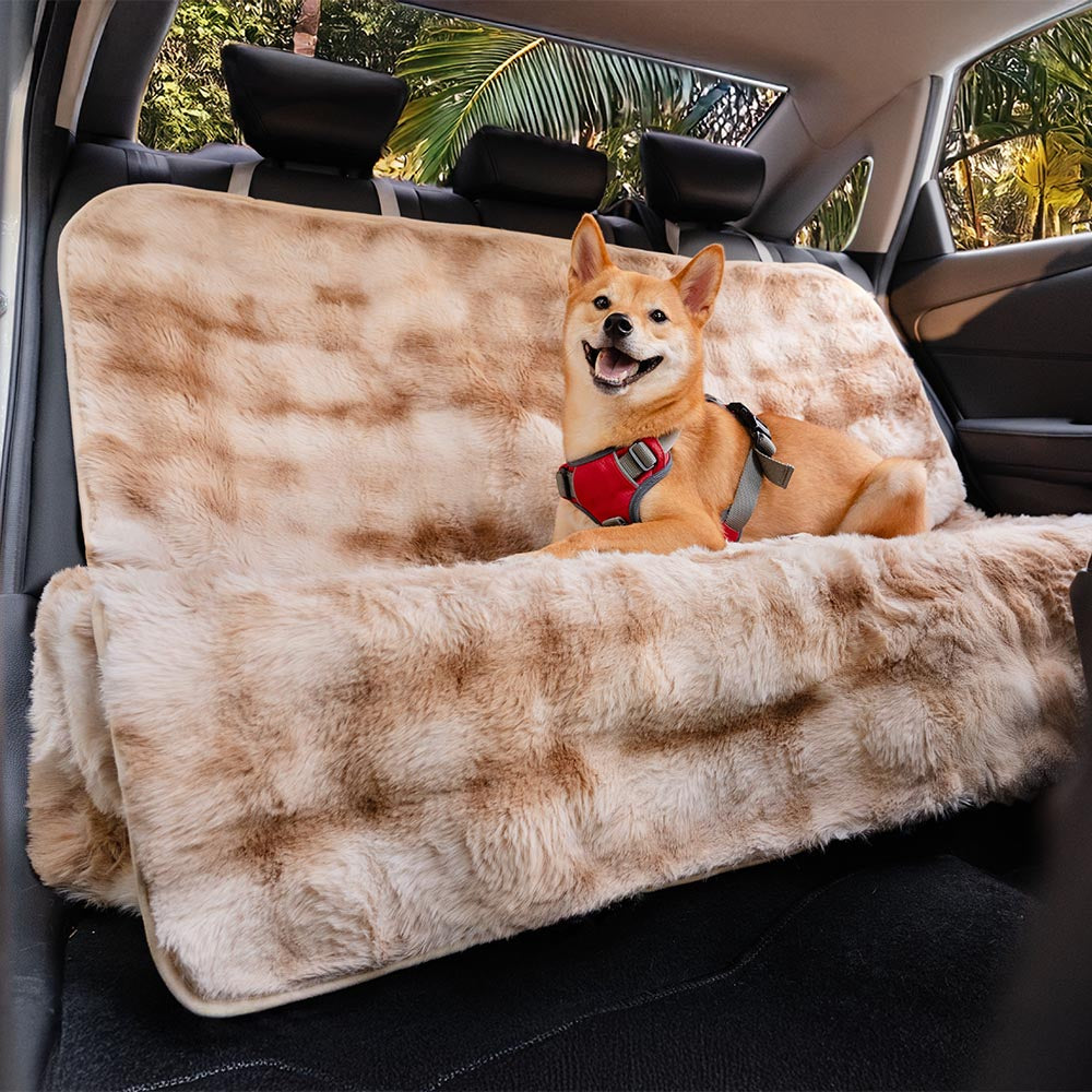 Dog enjoying a comfortable ride on a Surestep faux fur pet blanket covering a car seat.