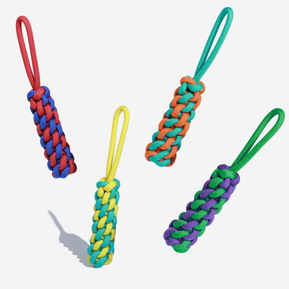 Colorful braided rope dog tug toy from a side angle, perfect for tugging games.