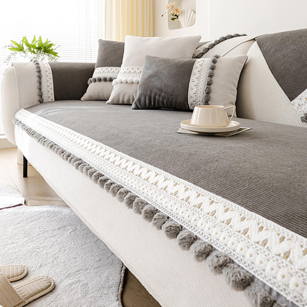 Corduroy couch cover with pom-poms on a sofa with pets