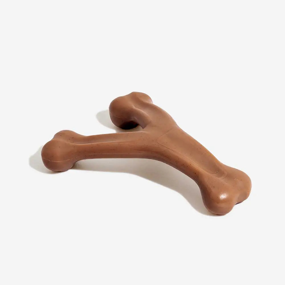 Bacon flavored dog chew toy being chewed by a happy dog