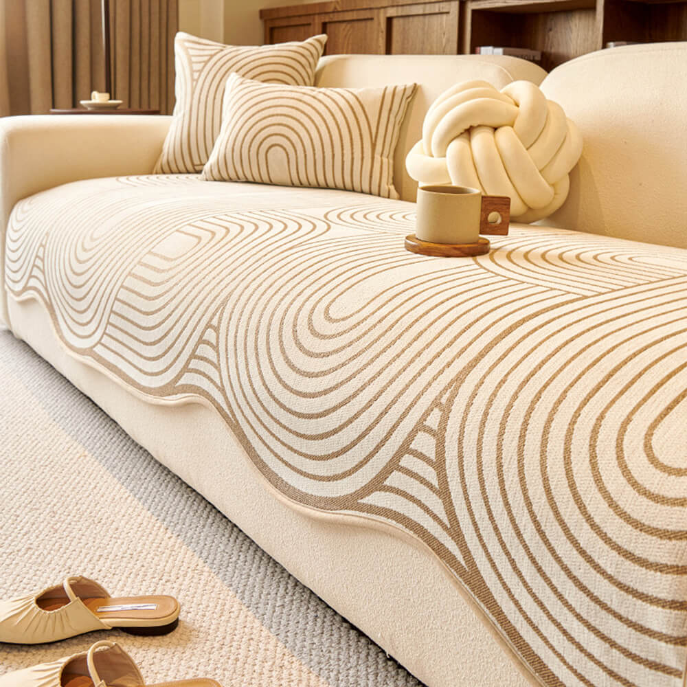 Modern living room with a neutral-toned irregular design couch cover with non-slip bottom protecting a sofa.