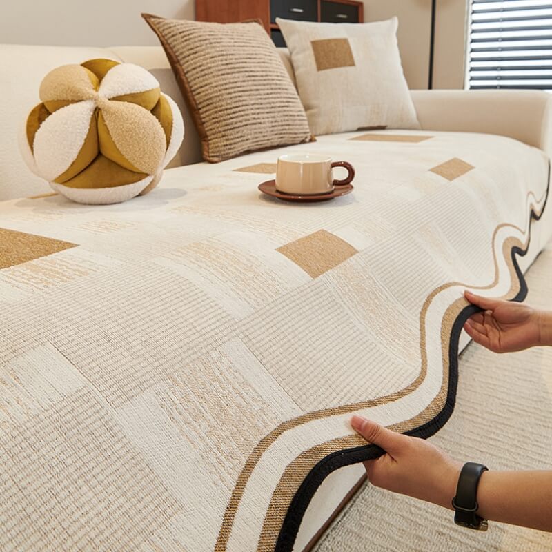 Vintage chenille patchwork sofa cover on stylish living room sofa