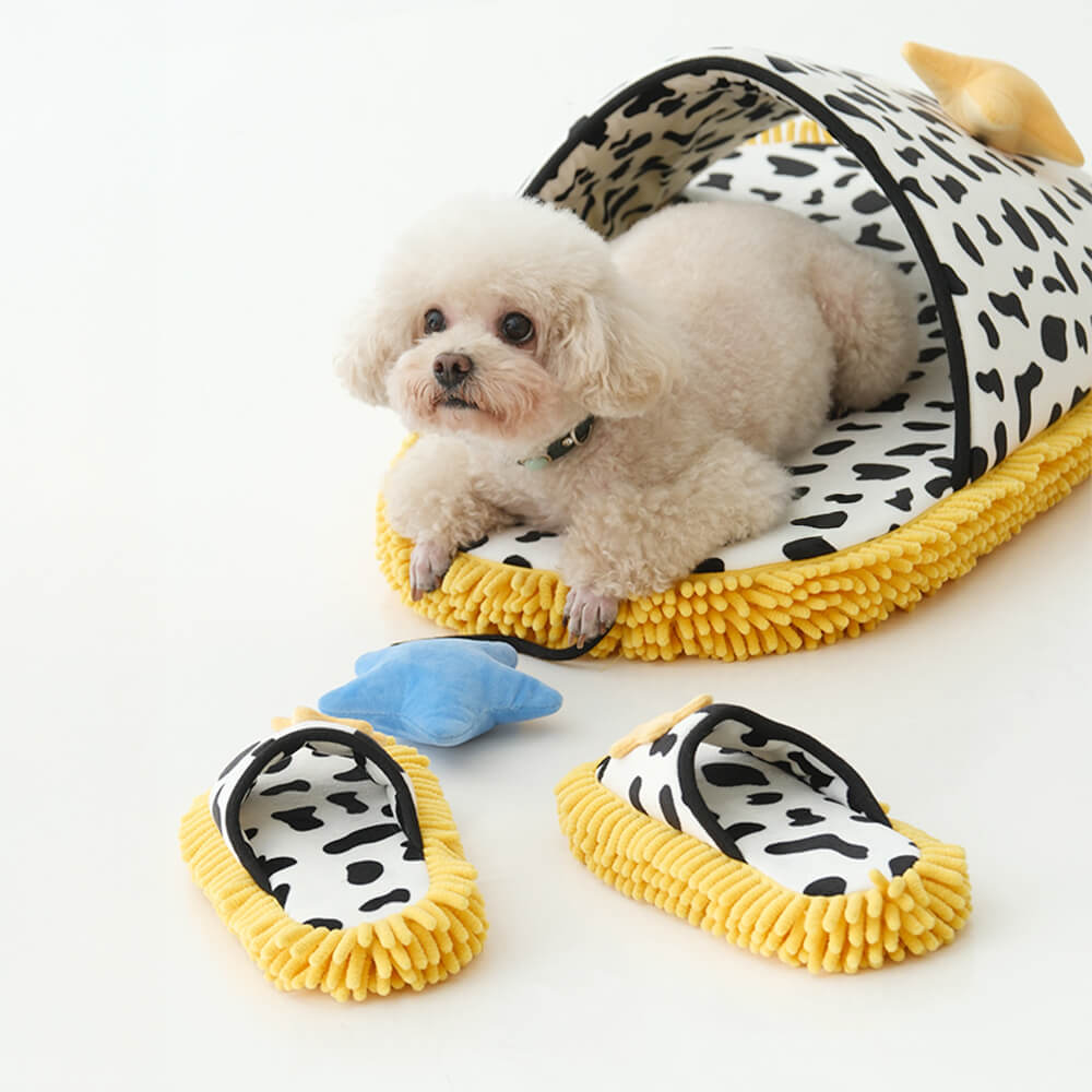 Cozy Cow Print Pet Bed with crinkle star toy attached, perfect for small dogs