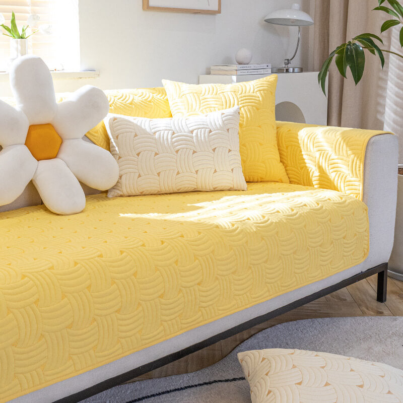 Cozy weave cotton quilted sectional couch cover in living room setting.
