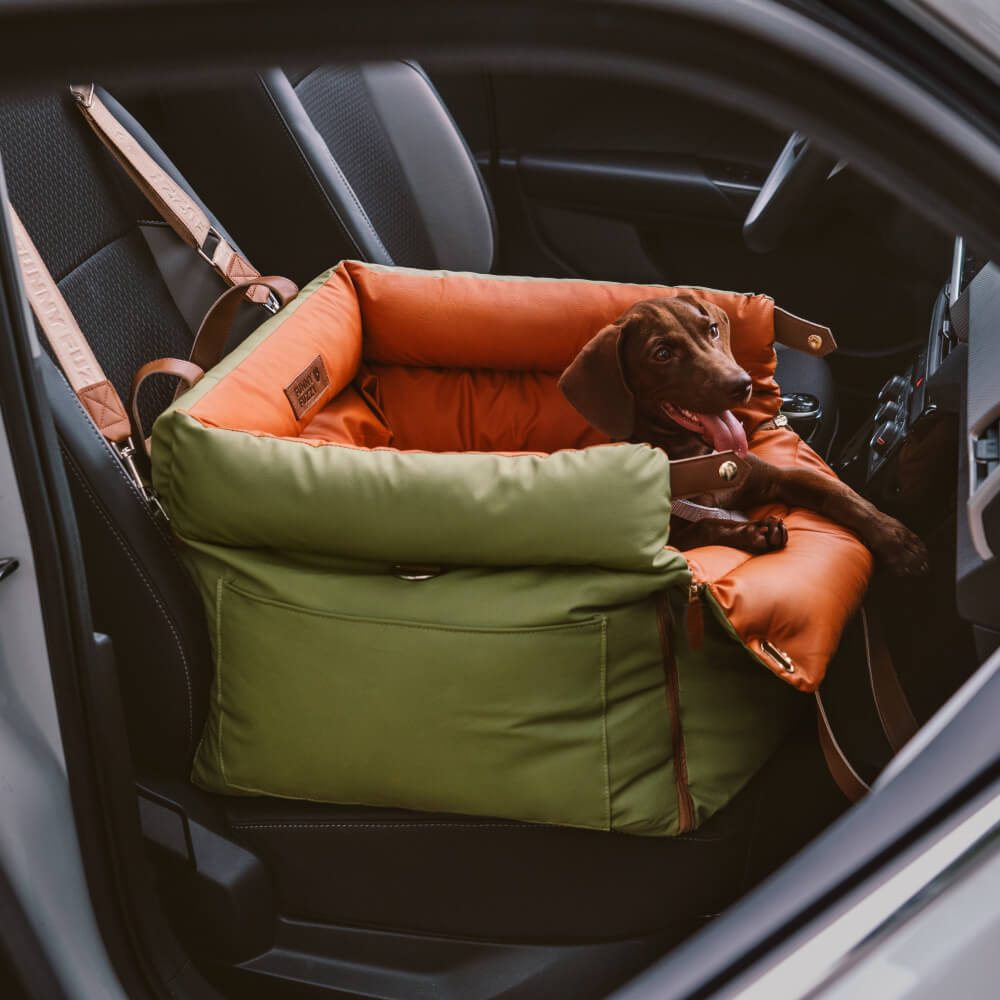 Top view showing padded dog car seat with adjustable safety leash and dual-tone faux leather finish