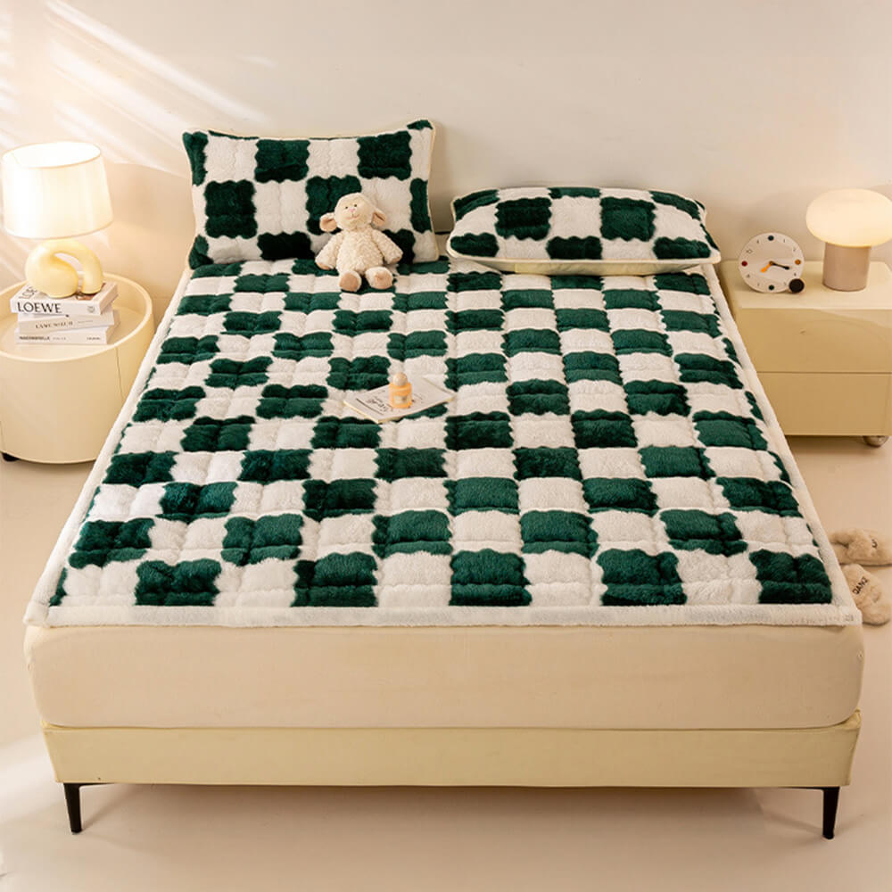 Overhead view of a checkerboard plush mattress topper spread on a bed, showing its cozy texture and stylish pattern.