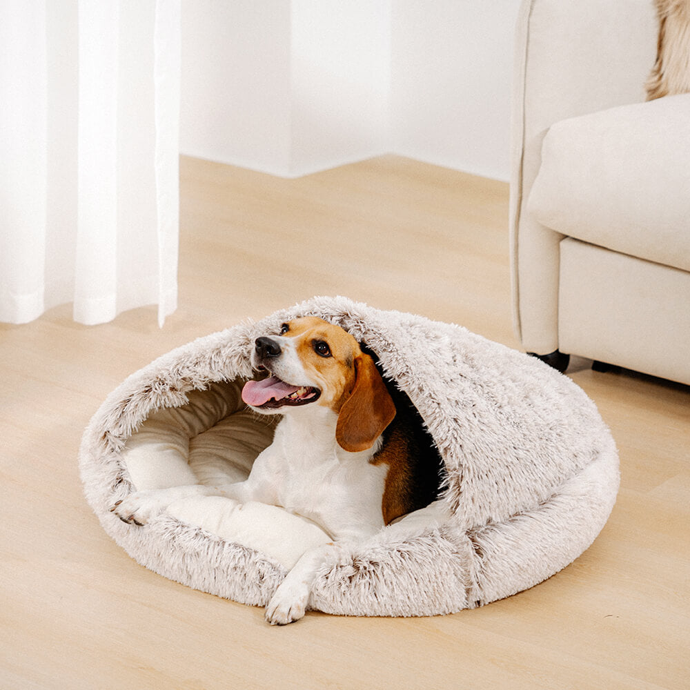 SnugHaven calming dog bed in beige, showing a small dog curled up inside the semi-enclosed nest