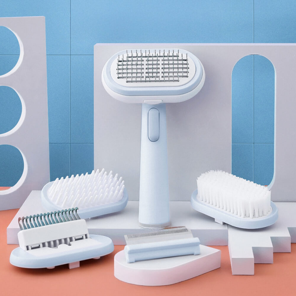 Close-up of the dog grooming brush with interchangeable heads and self-cleaning button
