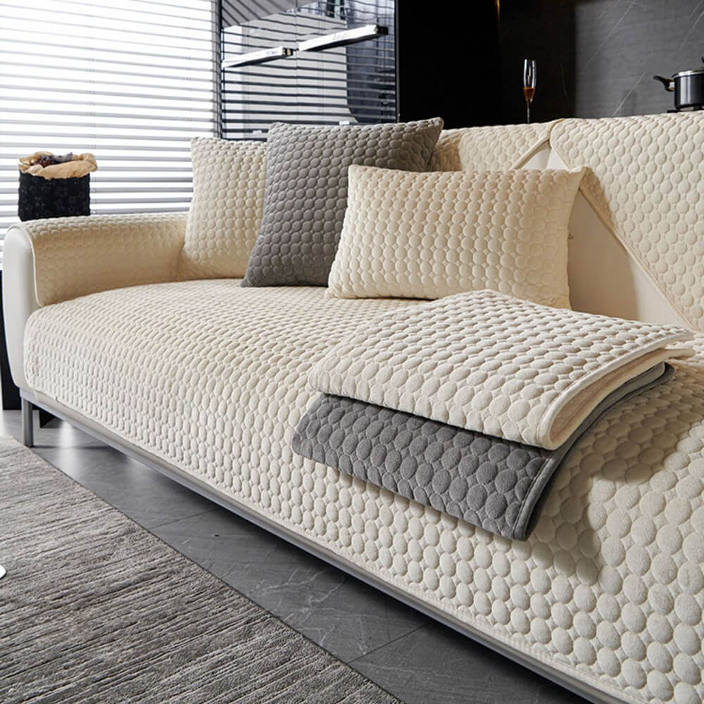 Close-up of soft quilted suede texture on sofa cover with non-slip backing