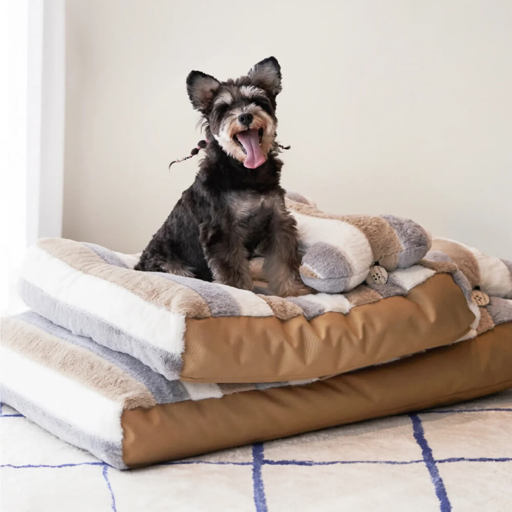 Top view of plush dog bed showcasing striped pillow and waterproof sides.