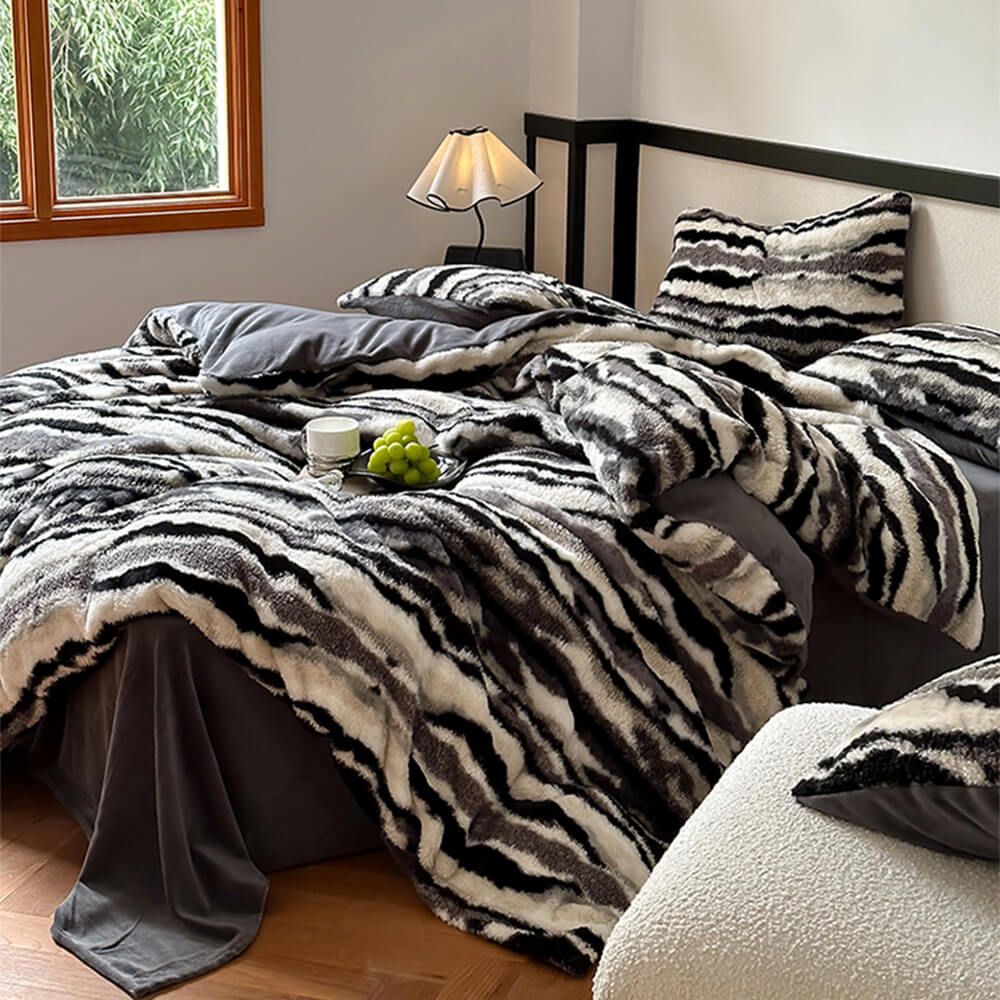Close-up of plush zebra print bedding with reversible faux fur side for winter warmth