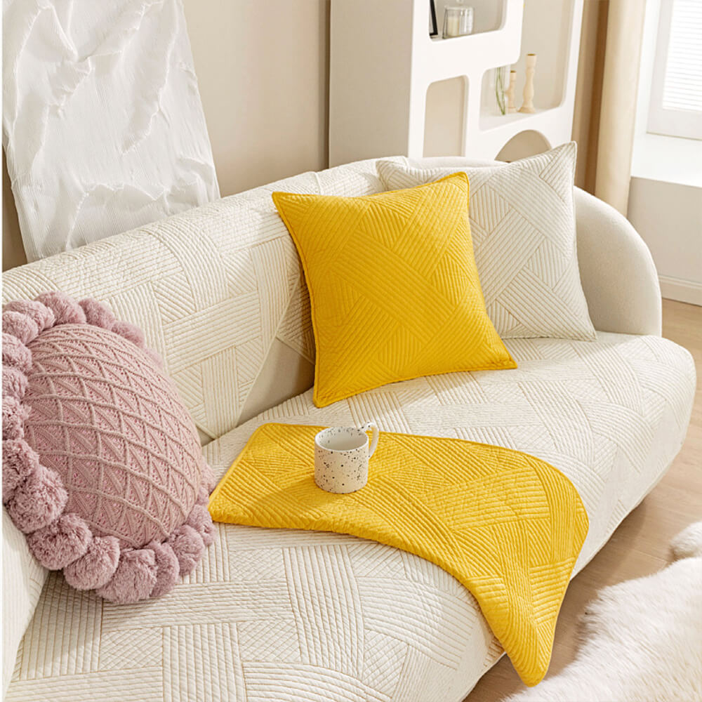 Top-down view of couch with minimalist geometric cotton cover showcasing texture and fit.