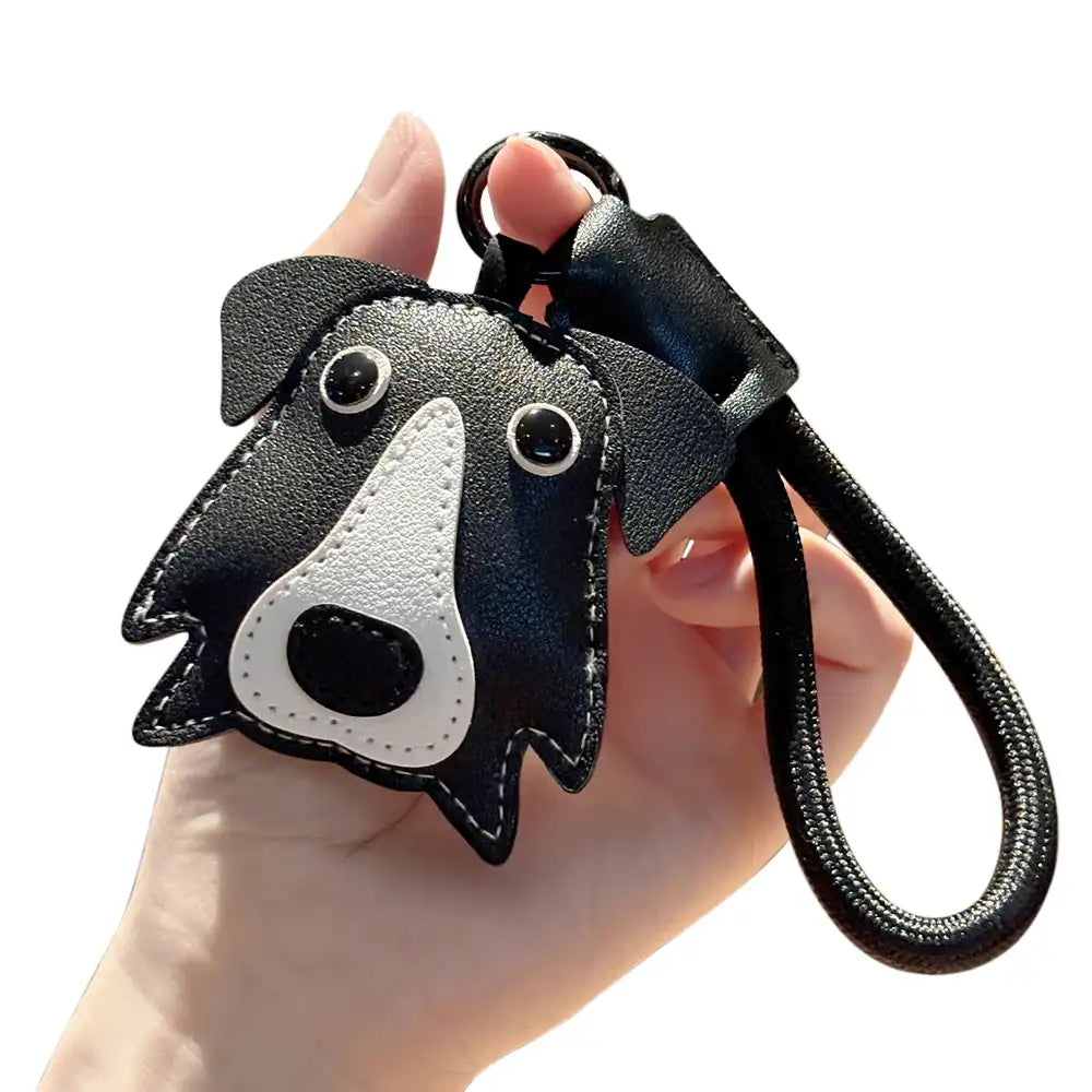 Cute faux leather dog keychain strap attached to a backpack, showcasing its durable design.