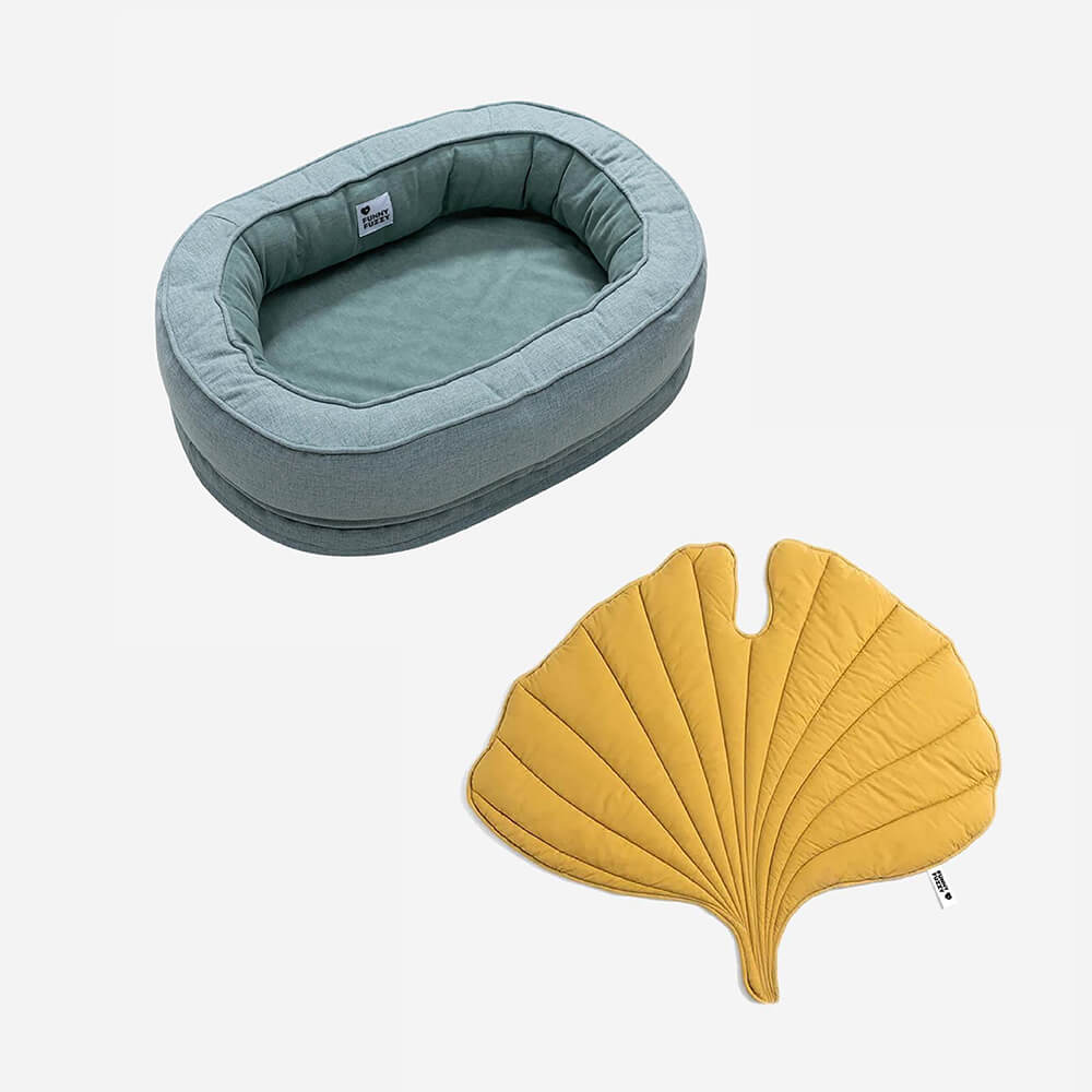 Leaf-shaped dog blanket in Elm Green laid out on a sofa.