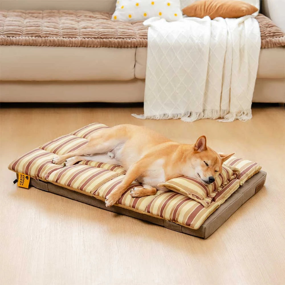 Angled view of the CloudNap orthopedic pet bed showing reversible striped layers and pillow support