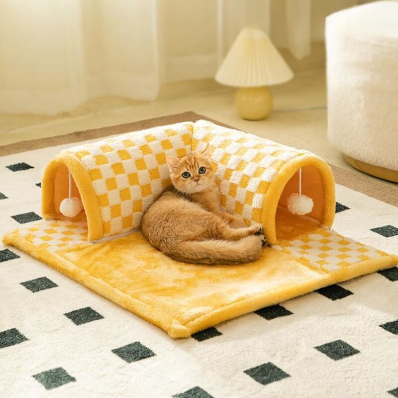 Plush checkered cat tunnel bed with plaid design in a cozy living room setting
