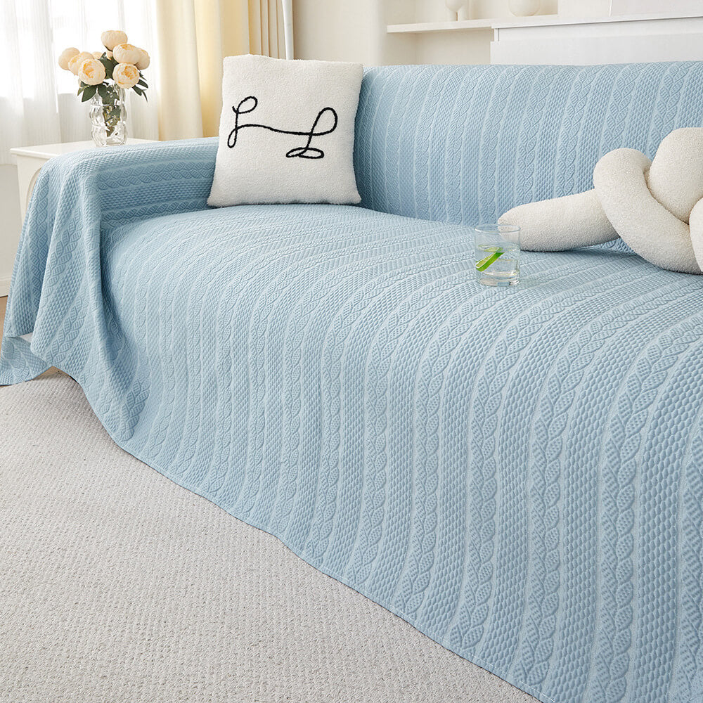Elegant wheat pattern ice silk couch cover draped smoothly over a modern grey sofa, showcasing its textured design and natural drape.