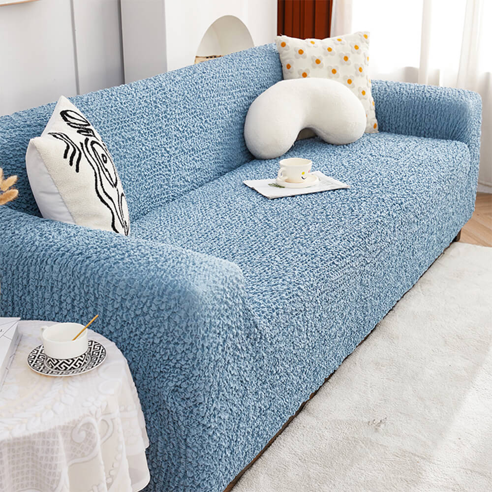 Angled view of the stretch sofa slipcover with bubble texture in a modern living room