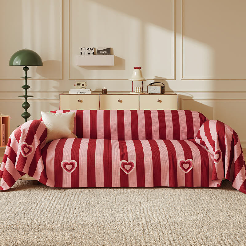 Angled view of chenille sofa cover in red stripe pattern on a modern sectional sofa.