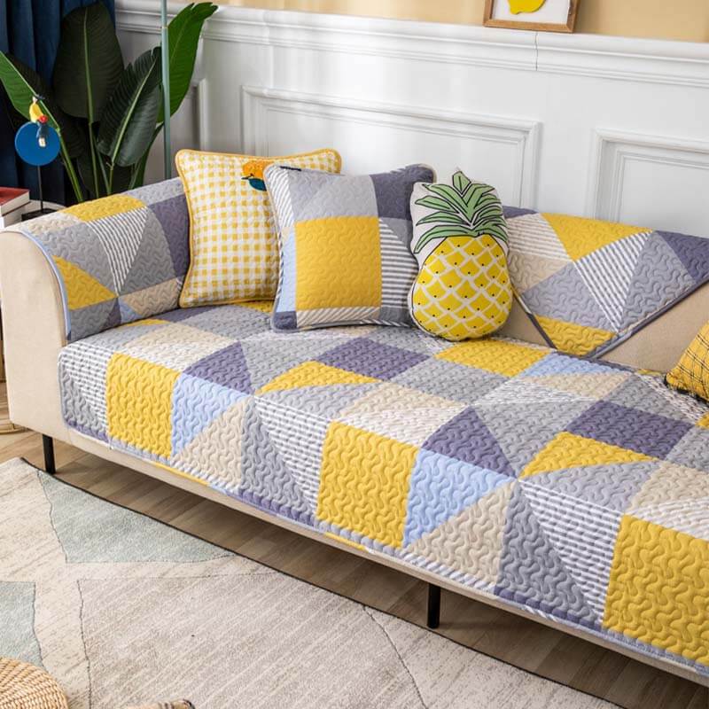 Front view of cotton couch protector with geometric pattern on a modern sofa