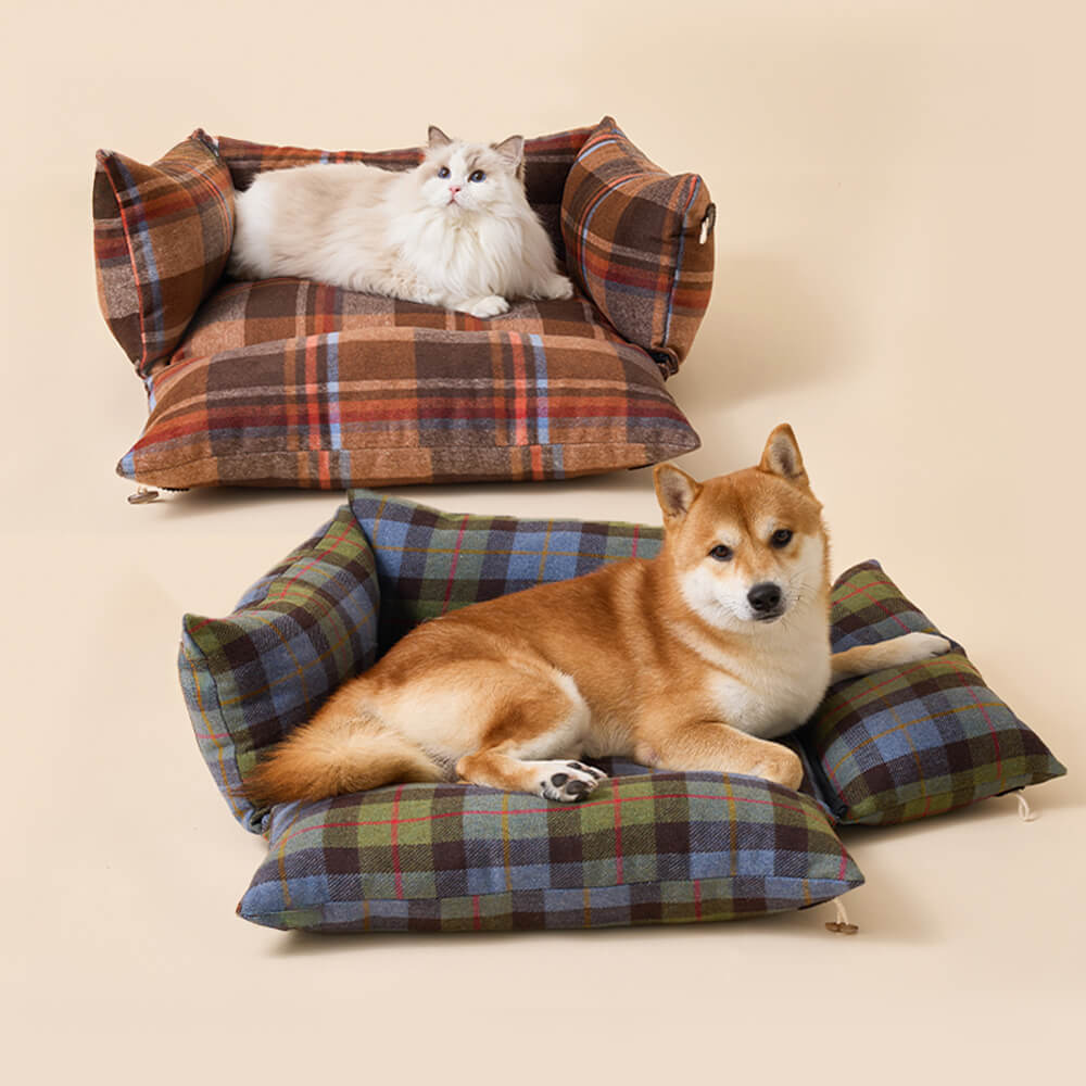 Close-up of plaid pet bed with horn button detail showing soft fabric and stylish design
