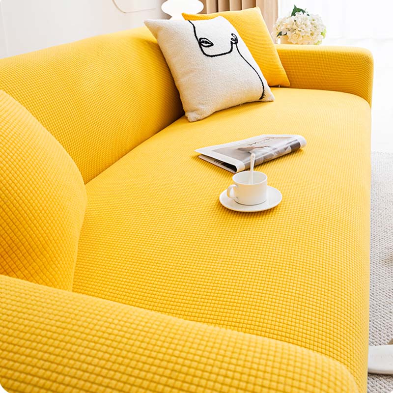 Close-up of cozy fleece sofa protector fitted on a couch, highlighting its texture and color.