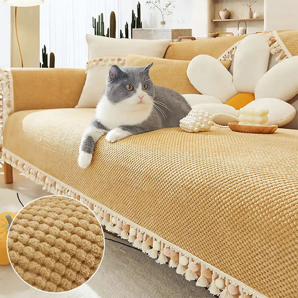 Boho corduroy sofa cover with tassels on a living room couch